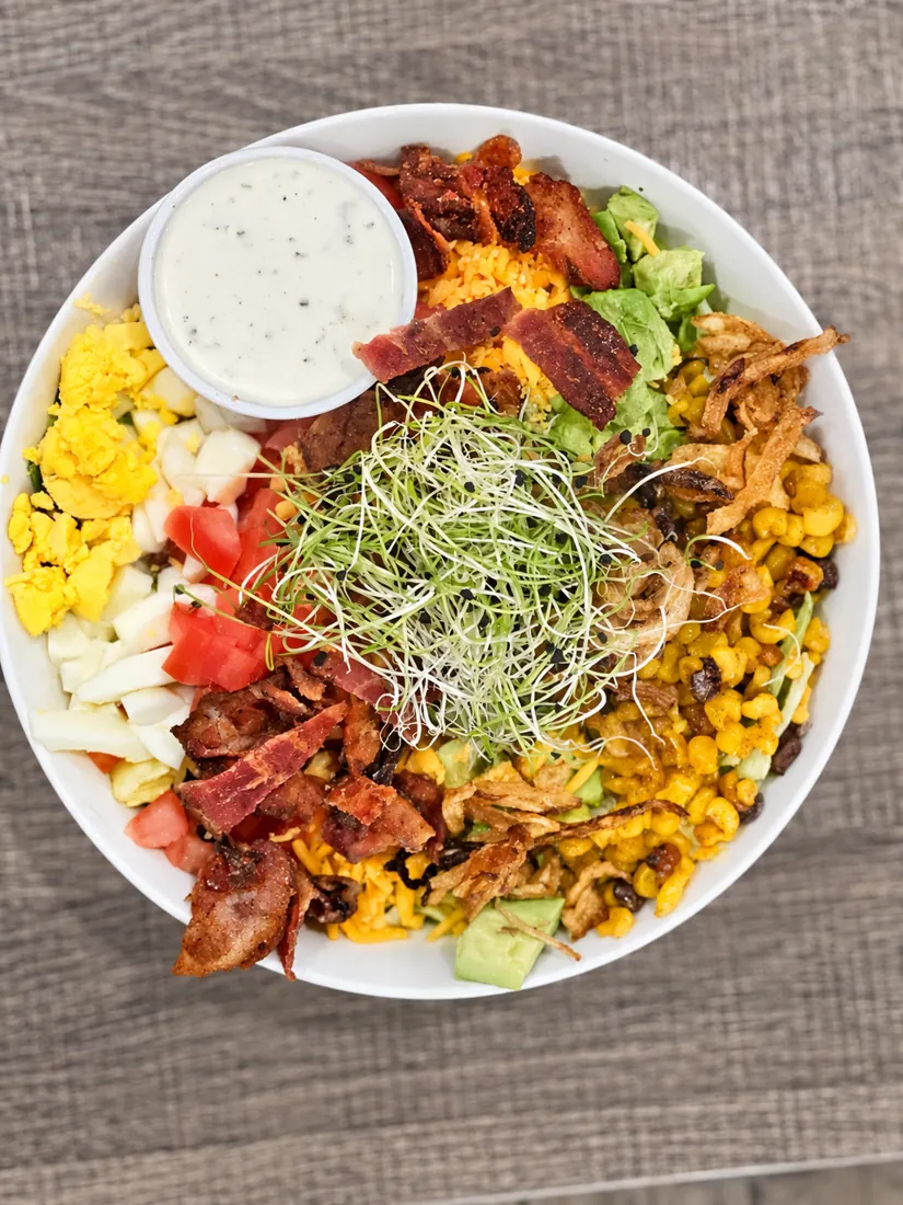 Cobb salad with bacon, egg, corn and ranch
