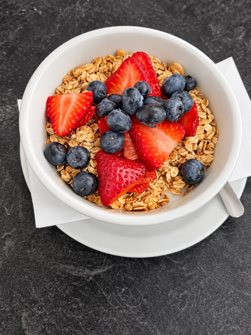 Yogurt bowl with granola, strawberries and blueberries