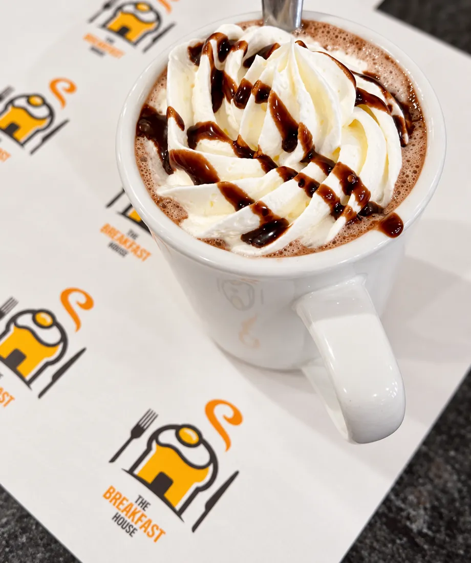 Hot chocolate with whipped cream and chocolate drizzle